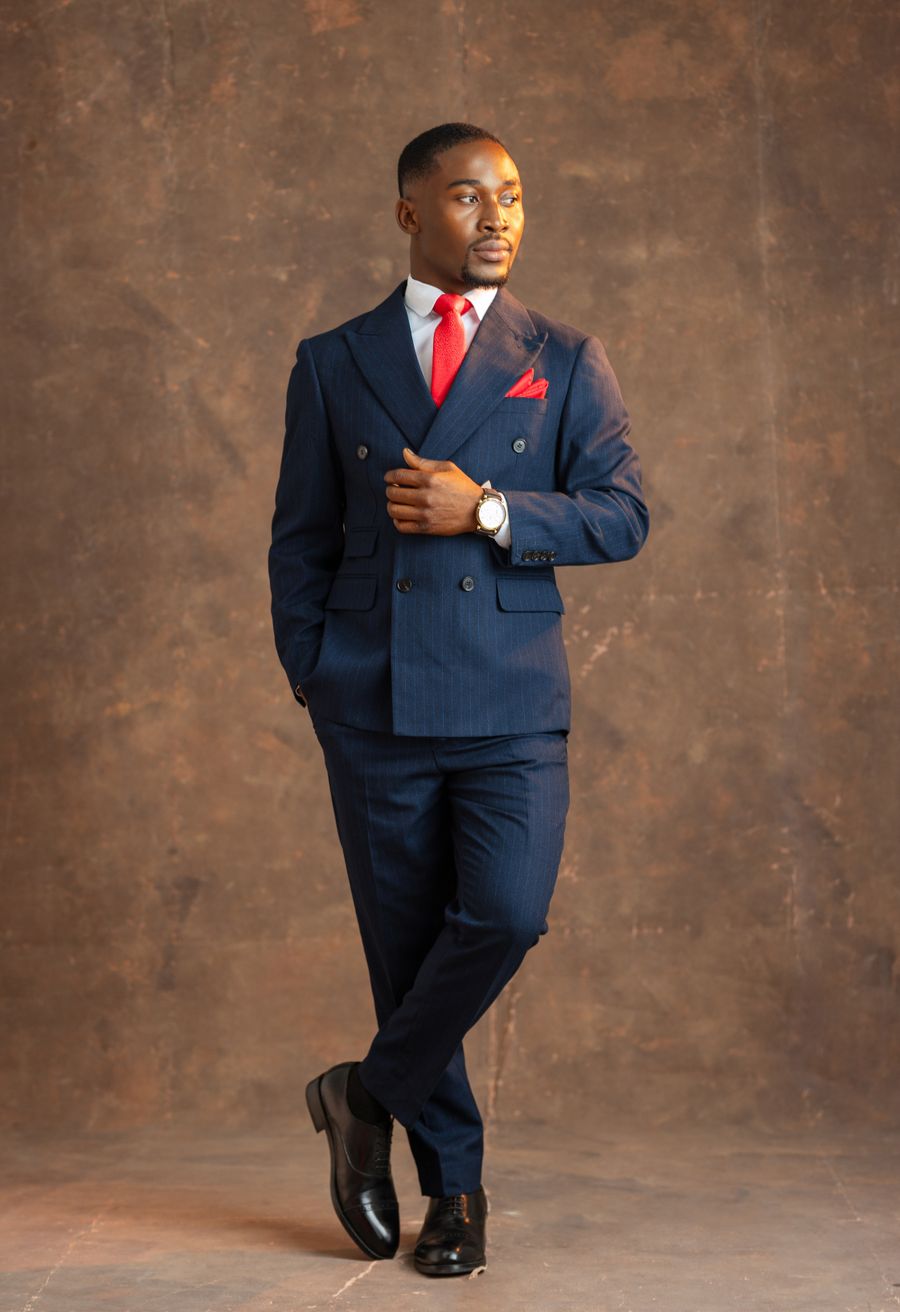 Man in a navy suit with a red tie